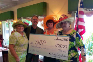 Ed Hinde and New Friends Club of Frederick holding a donation check